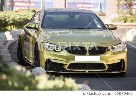 Yellow sport car with white xenon lights 65070465