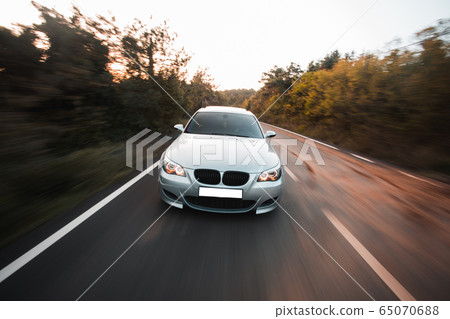 Silver offroader performance test drive in the forest 65070688