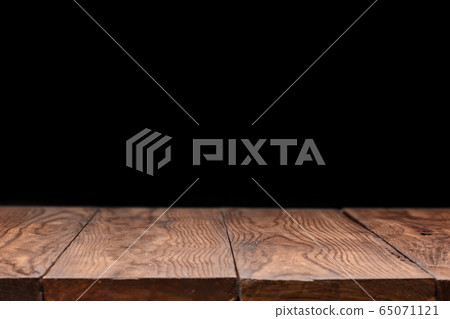 Empty wooden table backdrop on a black background. 65071121