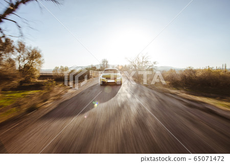 Green luxury brand sedan car driving on the highway in the daytime Green luxury brand sedan car driving on the highway in the daytime 65071472