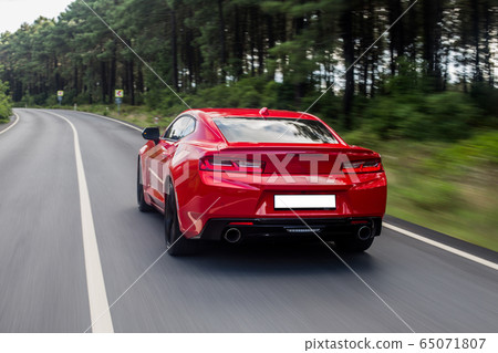 Red supercar in the performance autoshow Red supercar in the performance autoshow 65071807