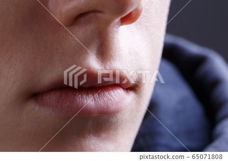 Photo of young woman's lips without make-up, close-up Photo of young woman's lips without make-up, close-up 65071808