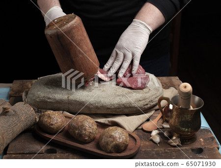 Cook makes meal meat with dark background 65071930