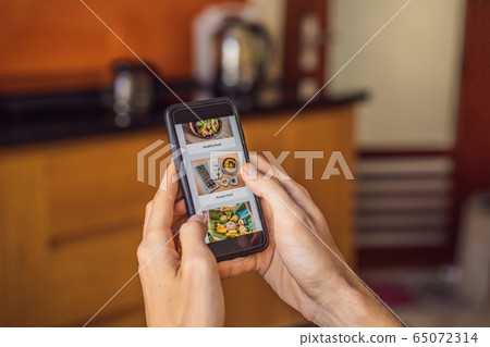 man orders food for lunch online using smartphone 65072314