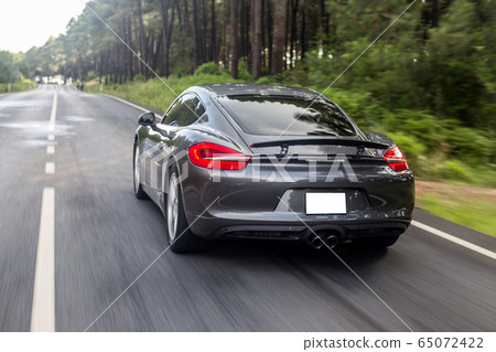 Grey color supercar motion in the forest 65072422