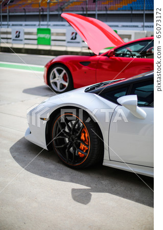 White and red racing cars in the stadium 65073172