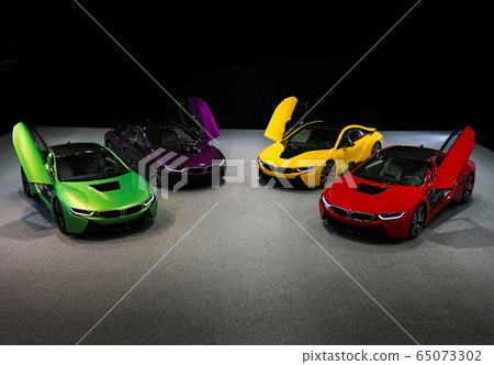 Multicolor sport car prototypes on the ground in the shadow 65073302