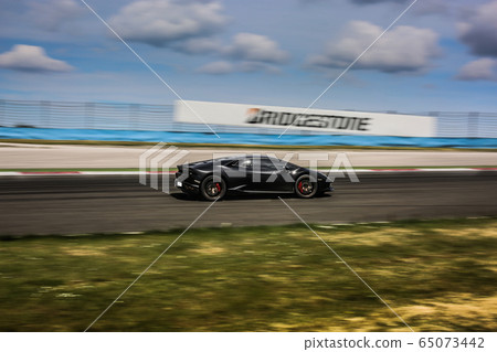 Black sport car racing in the highway 65073442