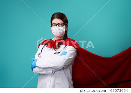 Doctor wearing surgical face mask in superhero cape. 65073664