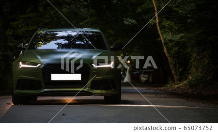 Slow motion drive of black sedan on the forest road in the darkness 65073752