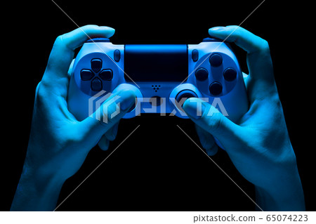 Hyman hands holding white video game gamepad in Hyman hands holding white video game gamepad in 65074223