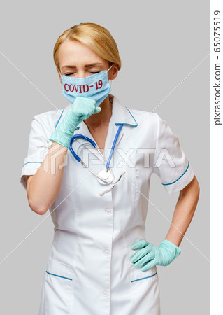 medical doctor nurse woman wearing protective mask and rubber or latex gloves - cough 65075519