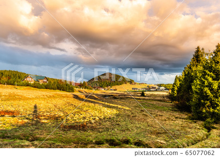 Bukovec mountain above Jizerka village at sunset time. Spring in Jizera Mountains, Czech Republic. 65077062