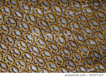 Dry mini salted pretzels as background. 65077147