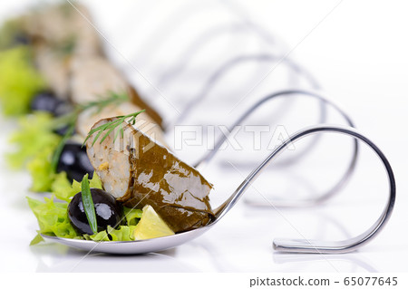 Greek appetizers on party spoons 65077645