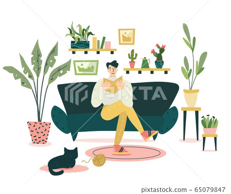 Guy is sitting on the coach and reading an interesting book in cozy and nice living room.  65079847