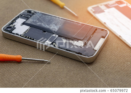 Closeup of phone battery repairs for smartphone By professional technician. 65079972