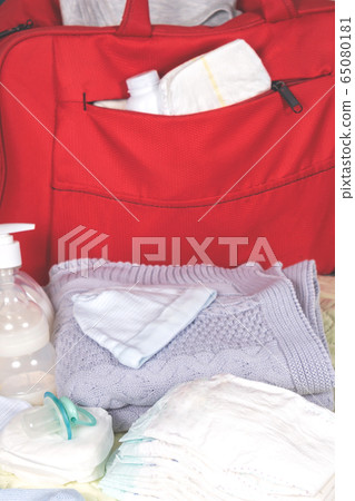 Diaper bag with newborn accessories in 65080181