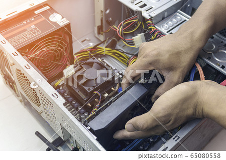 Technician repair graphic card cleaning computer pc. In the computer service center. Technician repair graphic card cleaning computer pc. In the computer service center. 65080558