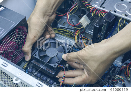 Technician computer repairing CPU cleaning for pc. In the computer service center 65080559