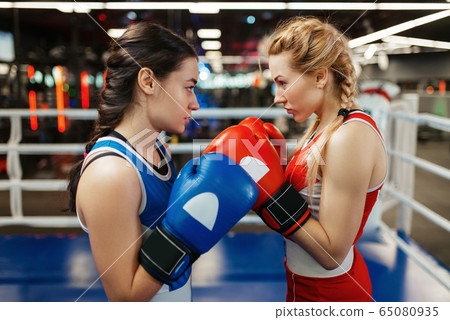 Women in red and blue gloves boxing on the ring Women in red and blue gloves boxing on the ring 65080935