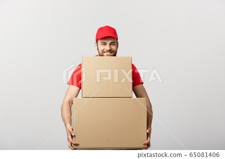 Delivery man doing surprise gesture holding cardboard boxes. 65081406