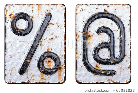 Set of symbol percent and at made of forged metal on the background fragment of a metal surface with cracked rust. 65081828