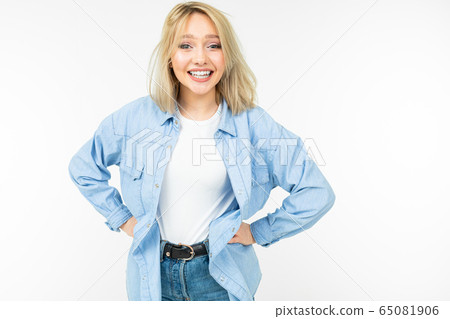 blond young girl in jeans style smiling on a white background blond young girl in jeans style smiling on a white background 65081906