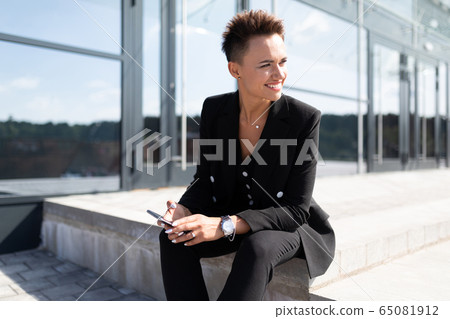 Female in office suit made an appointment and is waiting for colleague Female in office suit made an appointment and is waiting for colleague 65081912