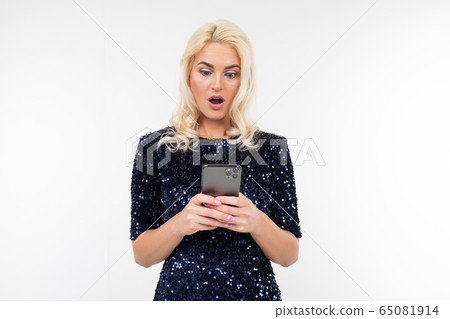 pensive lady in a shiny dress surfing the Internet from the phone on a white background with copy pensive lady in a shiny dress surfing the Internet from the phone on a white background with copy 65081914