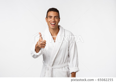 Portrait of happy African American handsome man laughing and showing thumb up gesture. 65082255