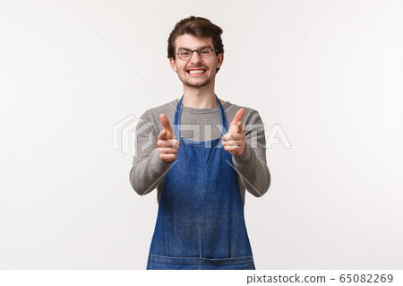 Portrait of excited handsome smiling employee in apron, coffee shop worker show thumbs-up in approval or like, barista guarantee quality of flavour and best service at store, white background Portrait of excited handsome smiling employee in apron, coffee shop worker show thumbs-up in approval or like, barista guarantee quality of flavour and best service at store, white background 65082269