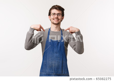 Portrait of confident good-looking professional male barista in apron, coffee shop owner brag he brew best coffee in town, pointing himself boastful, smiling like a pro, white background Portrait of confident good-looking professional male barista in apron, coffee shop owner brag he brew best coffee in town, pointing himself boastful, smiling like a pro, white background 65082275