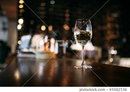 Aesthetic glass of white wine or water Aesthetic glass of white wine or water 65082536