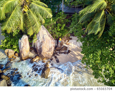 Man on beach at Seychelles aerial top view Man on beach at Seychelles aerial top view 65083704