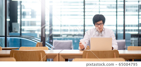 Asian man entrepreneur using laptop in office 65084795