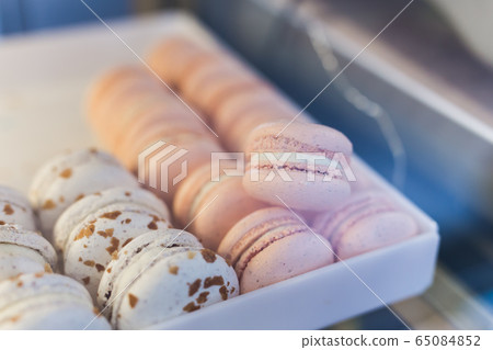 A french sweet delicacy, macaroons variety close-up on a showcase A french sweet delicacy, macaroons variety close-up on a showcase 65084852