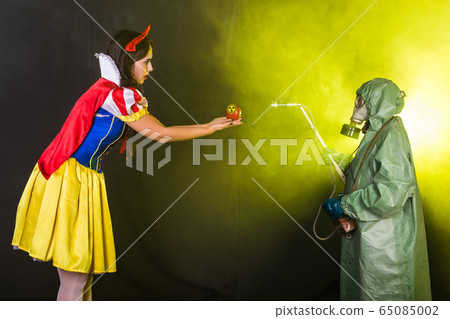 Woman holding hazardous radioactive apple. Nuclear and radiation measurement concept. 65085002