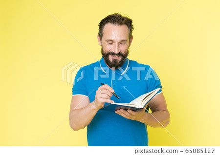Helpful checklist. Man mature bearded guy writing Helpful checklist. Man mature bearded guy writing 65085127