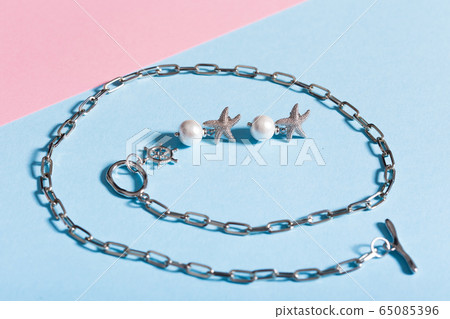 Top view of fashion jewelry and accessories on bright color background. Luxurious jewelry bijouterie and trendy concept. Top view of fashion jewelry and accessories on bright color background. Luxurious jewelry bijouterie and trendy concept. 65085396