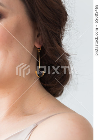 Close-up of woman wearing a Jewelry, bijouterie and accessories. Close-up of woman wearing a Jewelry, bijouterie and accessories. 65085468