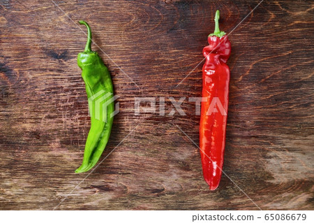 Two peppers on a table Two peppers on a table 65086679