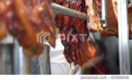Hong Kong honey glazed barbecue roasted pork hannging in Cantonese Chinese restaurant Hong Kong honey glazed barbecue roasted pork hannging in Cantonese Chinese restaurant 65086846