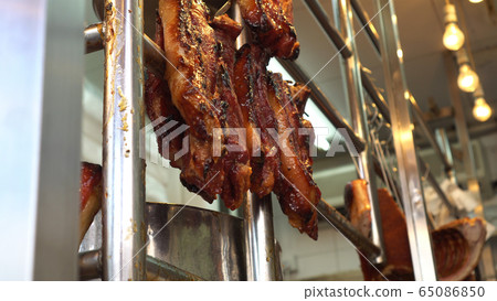 Hong Kong honey glazed barbecue roasted pork hannging in Cantonese Chinese restaurant Hong Kong honey glazed barbecue roasted pork hannging in Cantonese Chinese restaurant 65086850