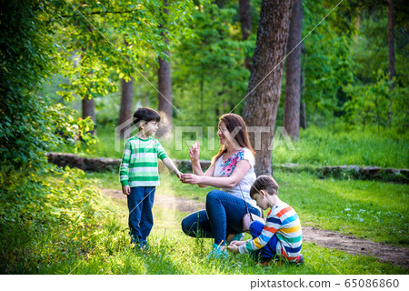 Young woman mother applying insect repellent to 65086860