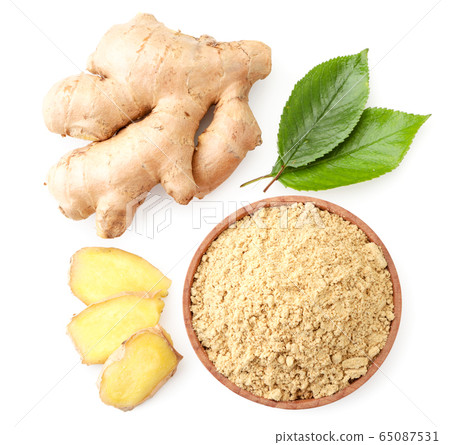 Ginger root, sliced and ground with green leaves Ginger root, sliced and ground with green leaves 65087531