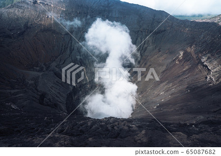 Photo of smoke volcano crater on Java island 65087682