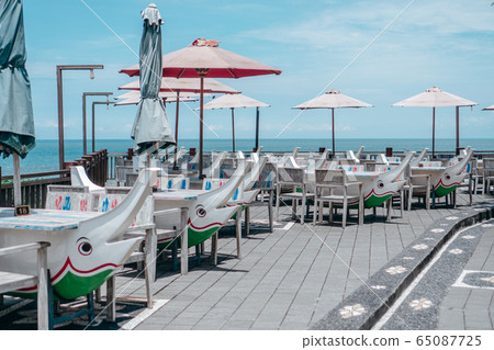 treet cafe with umbrellas and tables in sea treet cafe with umbrellas and tables in sea 65087725