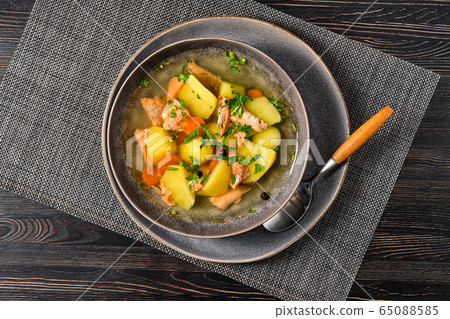 Top view of red salmon fish soup with potato and carrot Top view of red salmon fish soup with potato and carrot 65088585