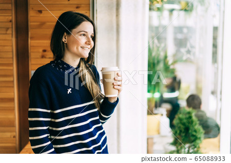 girl with a disposable cup of coffee 65088933